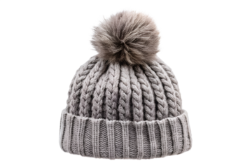 A grey knitted winter beanie with a fluffy pompom is displayed against a clean transparent background showcasing its cozy texture and stylish design