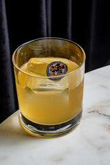 A stunning cocktail on marble displays a unique garnish that adds to its charm