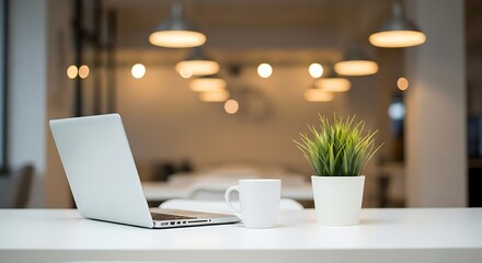 Modern laptop and coffee cup on a desk with soft lighting