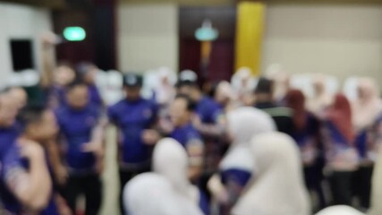 A group of people having fun in a team building game. Soft focus video