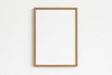 Wooden frame on wall, empty and elegant, waiting for a picture to adorn it.