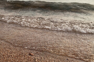 Beach sand background for summer holiday concept. Beach nature and summer sea water with sunlight sandy beach sparkling sea water