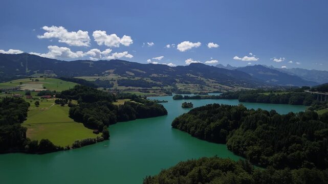 Le Bry small island on Lake Gruy&egrave;re Switzerland aerial drone turquoise blue water