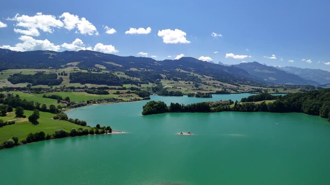 Lake Gruy&egrave;re Le Bry small island Switzerland aerial drone turquoise blue water