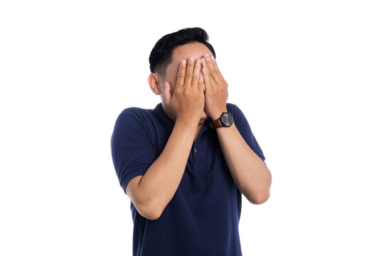 Embarrassed Asian man covering face with hands showing shyness and awkward expression isolated on transparent background