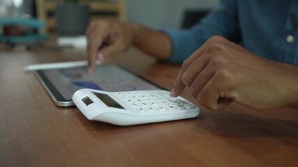 slow motion accounting man hand pressing on calculator for calculate about monthly profit of business for senior accountant job working concept - Powered by Adobe