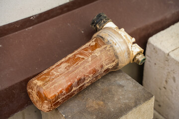Dirty water filter, close-up. Flask for filter element for water supply to the house