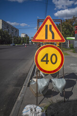 Road signs at the repair site on a summer day