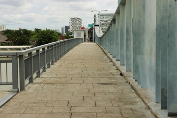 Fototapeta premium Pedestrian view of Krungthep Bridge, Chao Phraya river crossing truss bridge in Bangkok