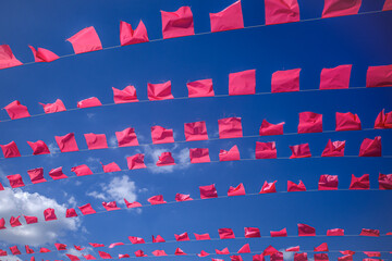 Garlands of flags in the blue sky on a summer day