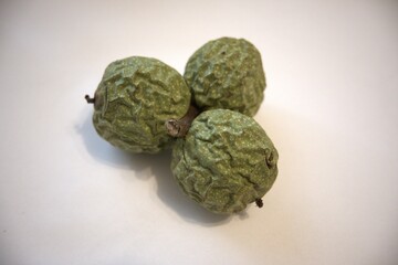 Walnuts in green shells on white background