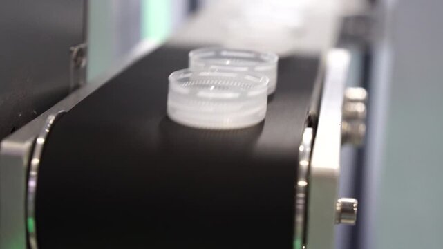 The production of plastic bottles caps on the conveyor belt.
