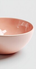 Close-up of a shallow, round, pastel pink bowl