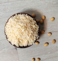 Okara soy plup in coconut bowl on wooden table - vegan asia ingredient 