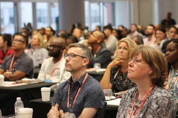 People at seminar sitting and listening