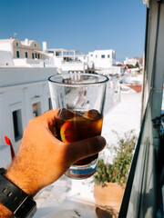 Enjoying a refreshing drink while overlooking the stunning architecture of Santorini