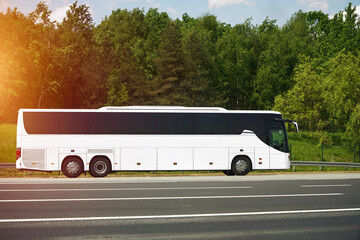 White tour bus parked on empty road