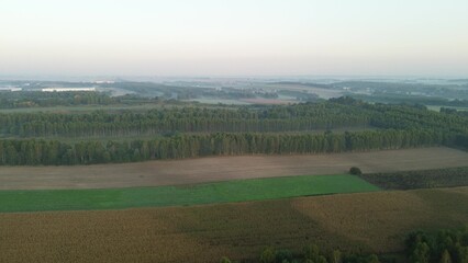 Obraz premium Foggy autumn fields and forests at sunrise