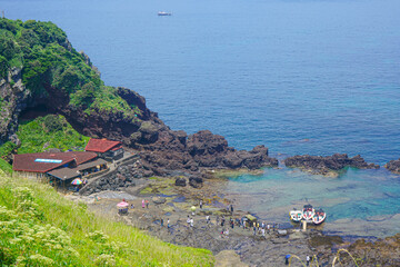 High, aerial view of the Seongsan-ri Haenyeo Woman Diver Village on the Umutgae Coast at Seongsan Ilchubong Park, also called Sunrise Peak, in Seogwipo, Jeju Island South Korea 