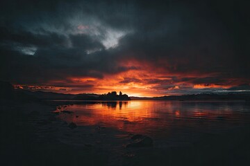 Dramatic sunset over a lake, dark clouds