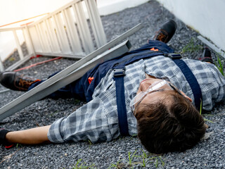 Accident and Injury at work. Safety first concept. Asian man worker lying down unconscious on the...