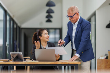Happy two business people work.Business planning, office trainee, cooperate work with colleague, Office worker discussing work plan of marketing.
