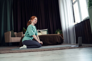 Practicing mindfulness and yoga at home during a quiet afternoon