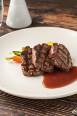 Juicy grilled filet medallions served with seasonal vegetables and sauce