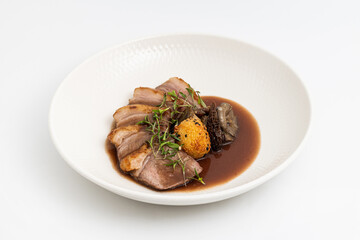 Sliced pan-seared duck breast with crispy skin and rich brown sauce