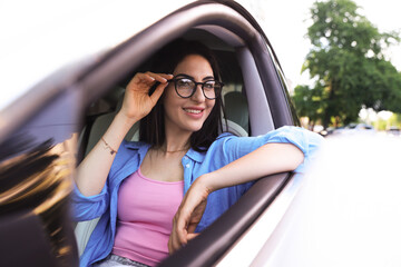 Woman in modern car, view from outside