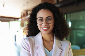Portrait of smiling Latin American woman in cafe