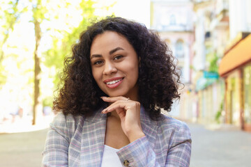 Portrait of smiling Latin American woman outdoors