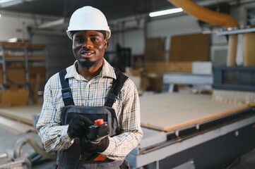 Furniture maker operating cnc machine in factory