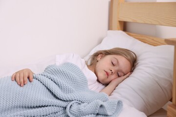 Little girl sleeping in bed at home