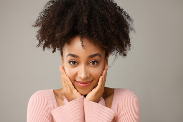 Portrait of beautiful Brazilian woman on gray background