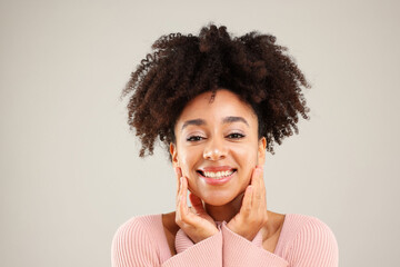 Portrait of beautiful Brazilian woman on gray background