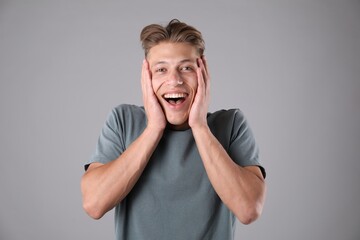 Portrait of surprised man on grey background