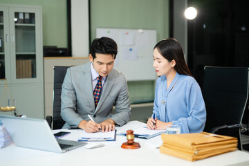 business people and lawyers discussing contract papers sitting at the table. Concepts of law, advice, legal services.