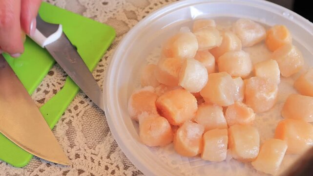 Scallops without shells, shrimp and squid on a plate, cooking seafood