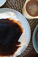 Close up Basque burnt cheese cake served with hot coffee, Traditional classic Spanish dessert cooked at high heat