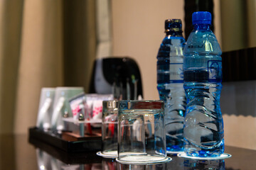 drinking water in the bottle and glass cup