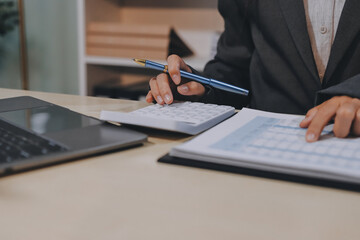 Entrepreneur Asian businessman and businesswoman discussing new business project in tablet in...
