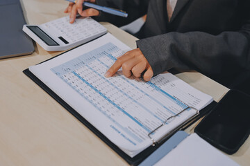 Entrepreneur Asian businessman and businesswoman discussing new business project in tablet in...