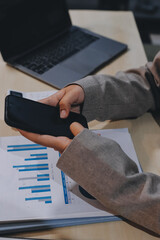 Entrepreneur Asian businessman and businesswoman discussing new business project in tablet in...
