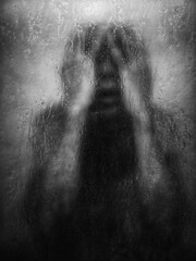 Silhouette behind foggy glass, hands pressed, emotional tension.