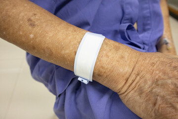 Close-Up of Elderly Patient's Wrist with ID Band in Hospital Setting