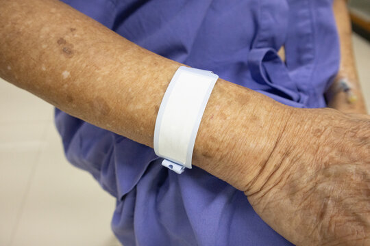Close-Up of Elderly Patient's Wrist with ID Band in Hospital Setting