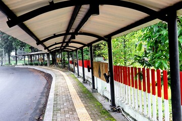 A pedestrian-friendly sidewalk with canopies, accessibility guide paths for people with...