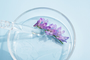 Face serum close-up on blue background. Collagen, hyaluronic acid for skin care. Achievements of...