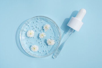Dropper glass branding mockup. Cosmetic pipette. Trendy blue background. Concept of organic and...